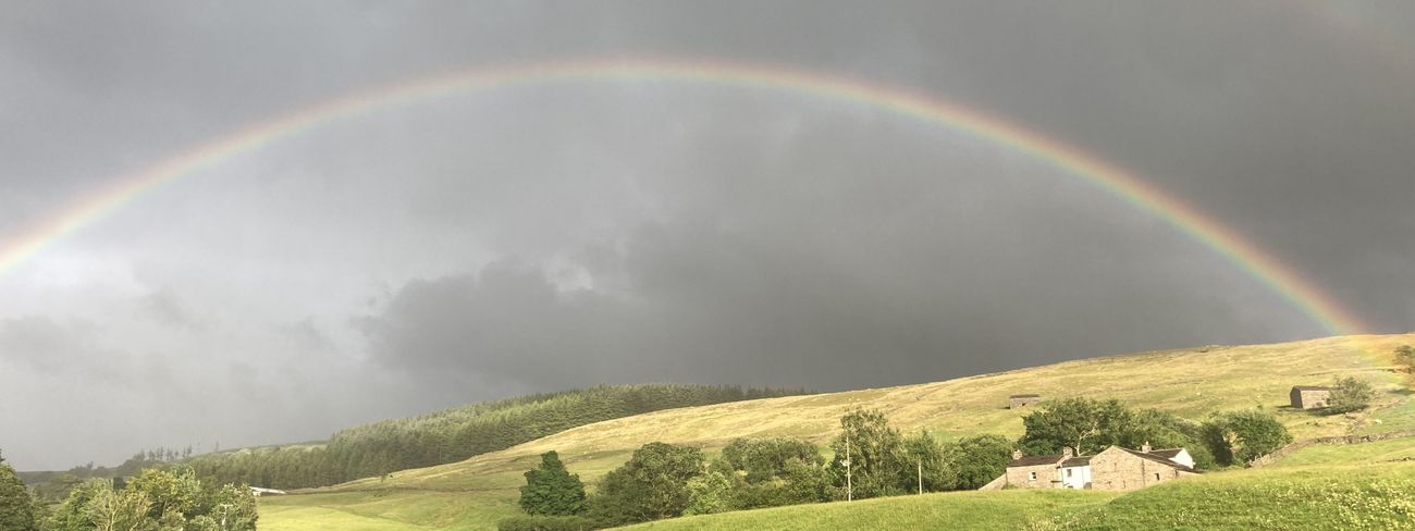Rainbow over stone cottages in Garsdale